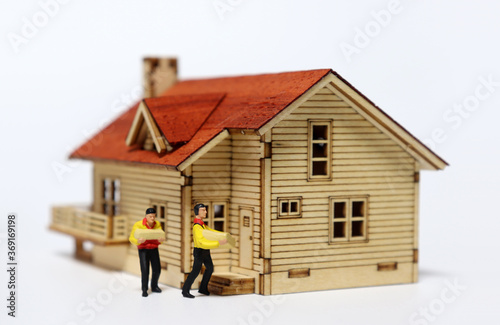 A miniature house and two miniature courier. 