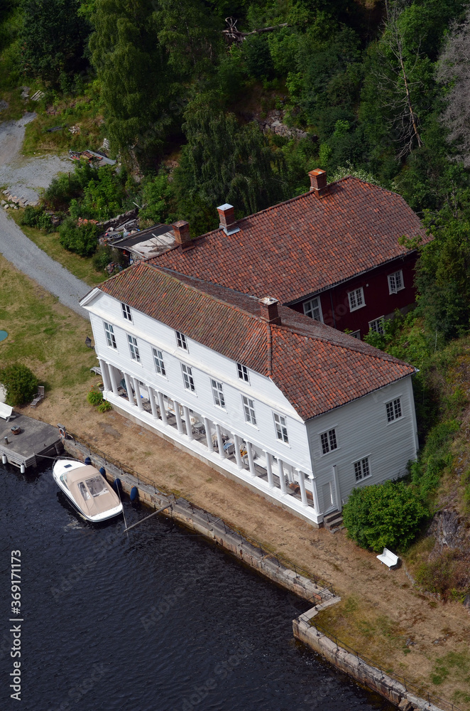 Fototapeta premium Typical Swedish nature and houses on the shore of the fjord. View from the high bridge over the fjord. The border of Norway and Sweden.Near the town Selater,Sweden