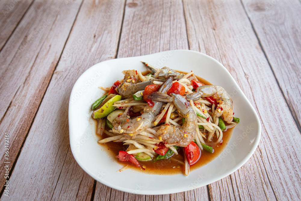 Papaya salad with shrimp in white on black background. Thai food delicious and popular Papaya salad with shrimp in white on black background. Thai food delicious and popular
