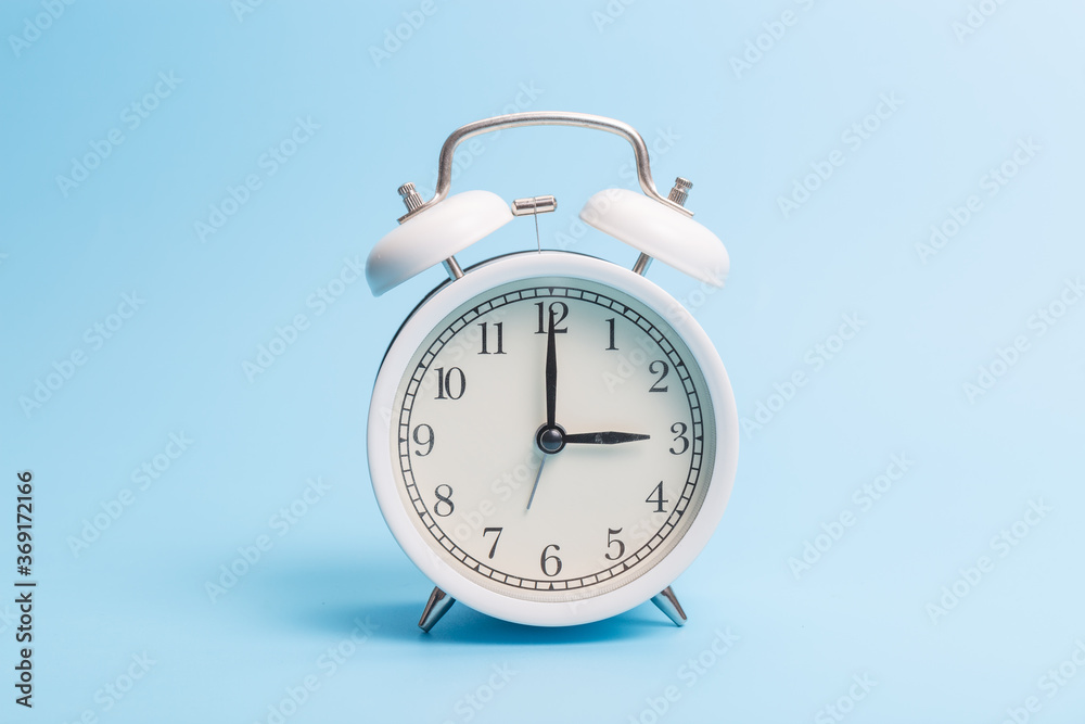 Alarm clock on blue background Alarm clock on blue background