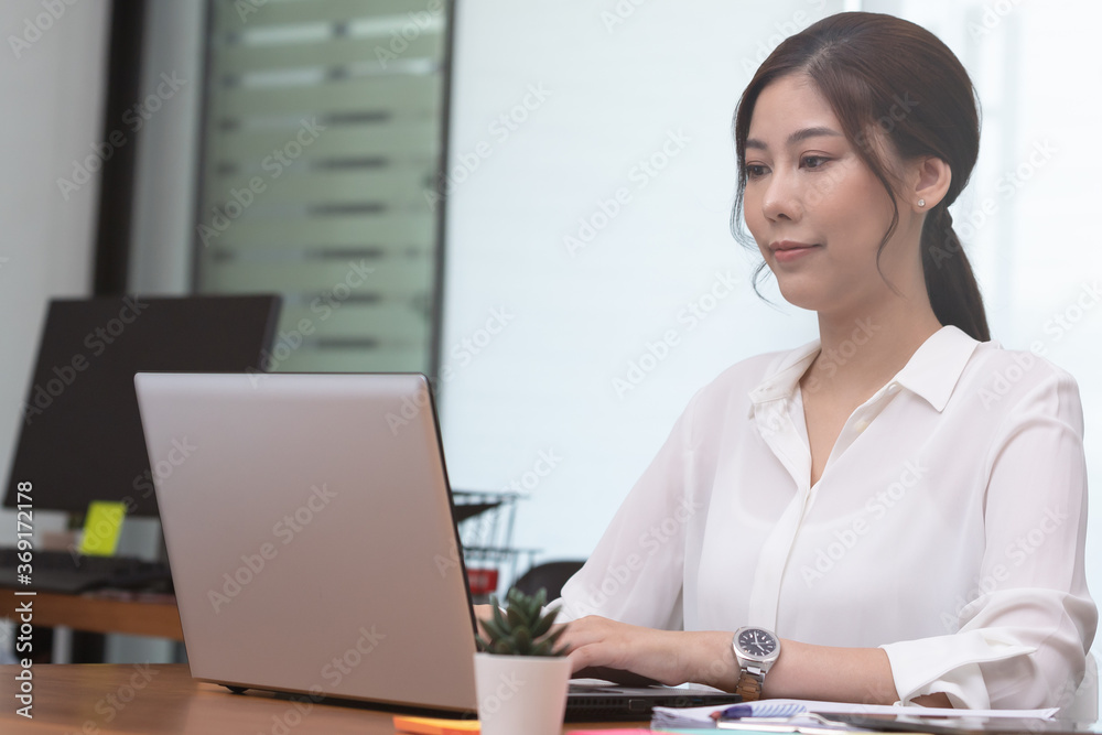 Business asian woman happy working job on laptop in office. Business asian woman happy working job on laptop in office.