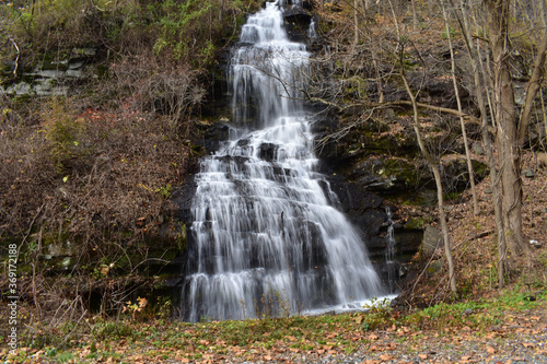 Fototapeta Naklejka Na Ścianę i Meble -  A Small Waterfall Flowing Down a Steep Cliff