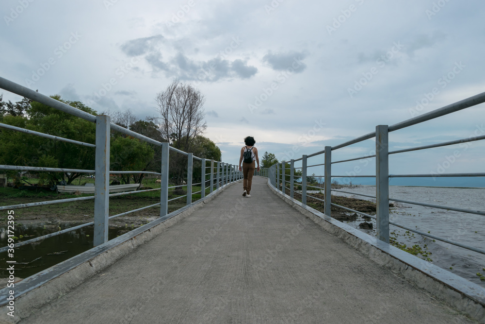 woman walking on bridge