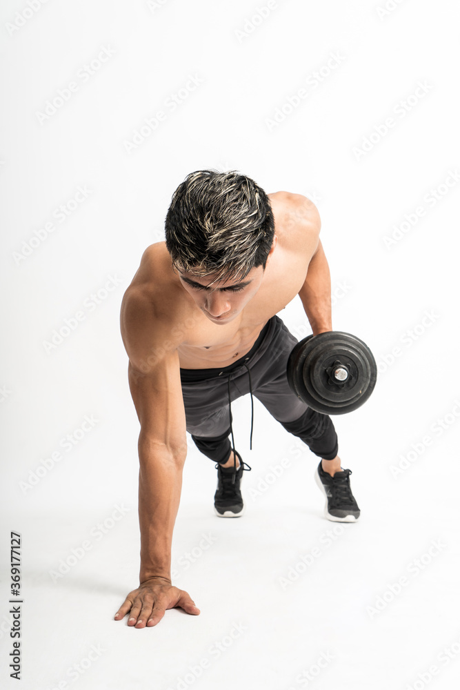 front angle view of muscle man without clothes do push up exercises with a dumbbell in one hand on an isolated background front angle view of muscle man without clothes do push up exercises with a dumbbell in one hand on an isolated background