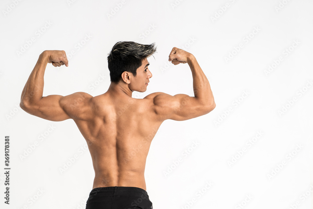half body image of young man showing muscular body stand facing back on isolated background half body image of young man showing muscular body stand facing back on isolated background