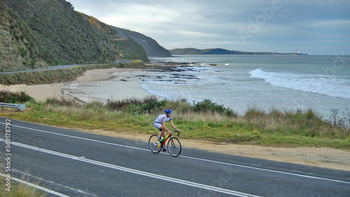 lone cyclist on the scenic winding Great Ocean Road in Victoria Australia photo