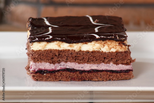 Layer cake with fruit and cream fillings decorated chocolate icing