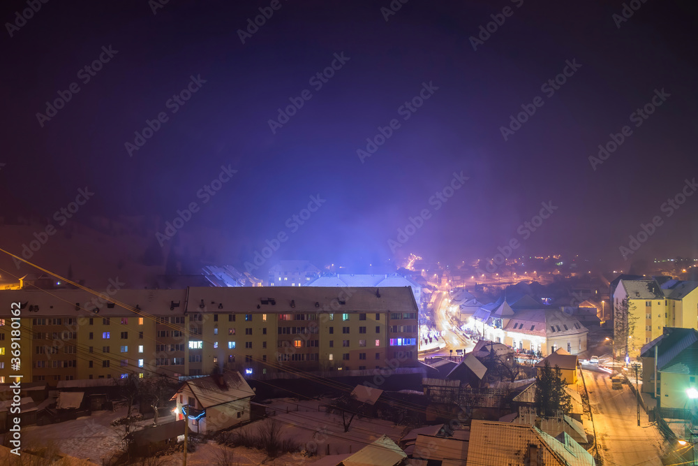 Mountain resort landscape covered by snow. Top view during night of Borsec, Romania
