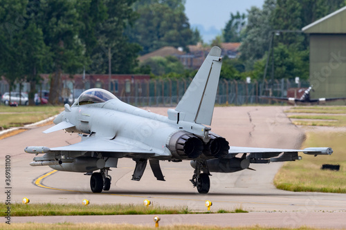 Fighter jet taxiing at a military airbase.