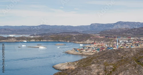 Greenland view of Ilulissat City and icefjord. Famous tourist destination in the actic affected by climate change and global warming. photo