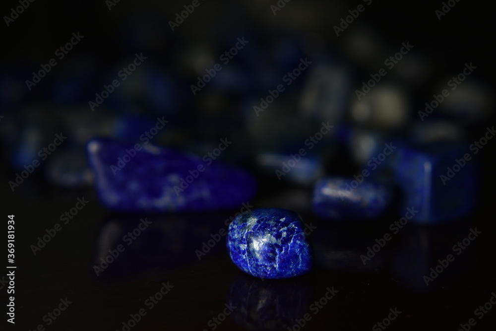 Lapis Is a beautiful natural gemstone on a wooden floor Lapis Is a beautiful natural gemstone on a wooden floor