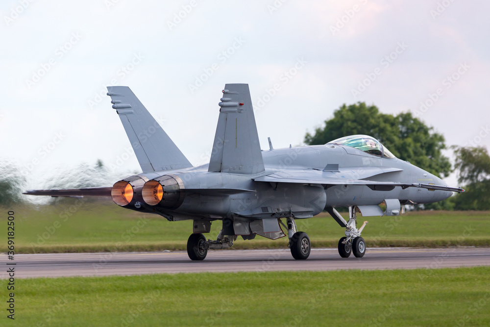 Advanced military fighter jet aircraft taking off with full afterburner glowing. Advanced military fighter jet aircraft taking off with full afterburner glowing.