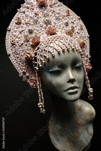 Head of mannequin in creative pink kokoshnick with jewels and pearls