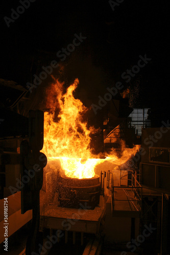 Steel production in electric furnaces. Sparks of molten steel. Electric arc furnace shop EAF. Metallurgical production, heavy industry, engineering, steelmaking