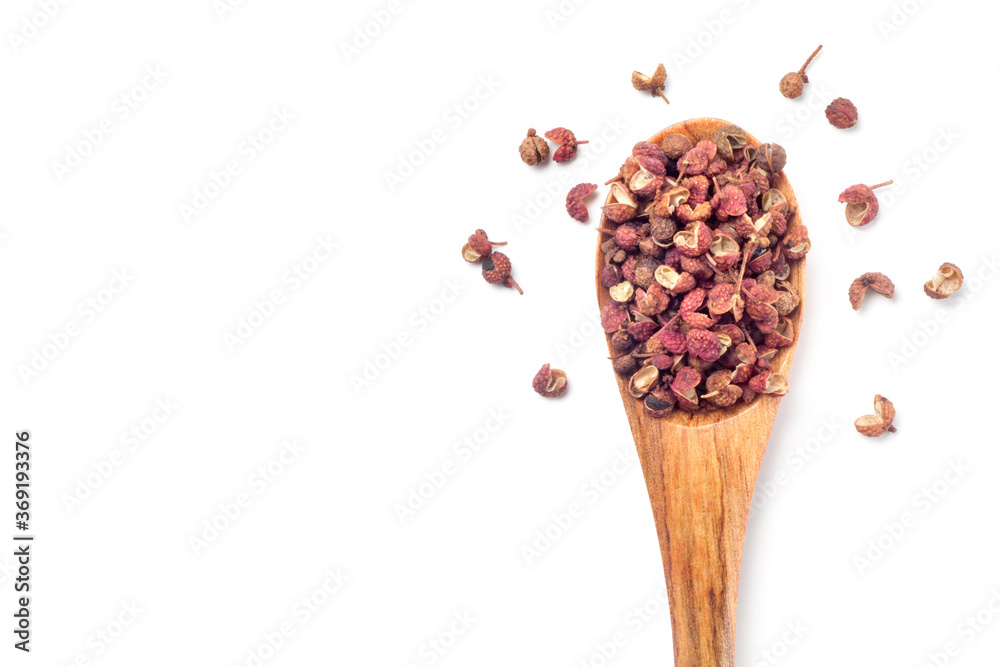 sichuan pepper (zanthoxylum bungeanum) in a wooden spoon isolated on white background. Chinese prickly ash. top view. - obrazy, fototapety, plakaty 