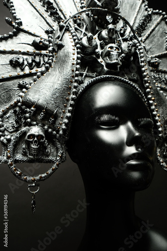 Head of mannequin in creative metal kokoshnick, dark studio background © EVGENY FREEONE