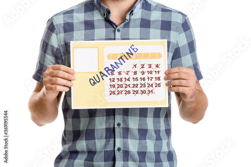 Young man holding calendar ...