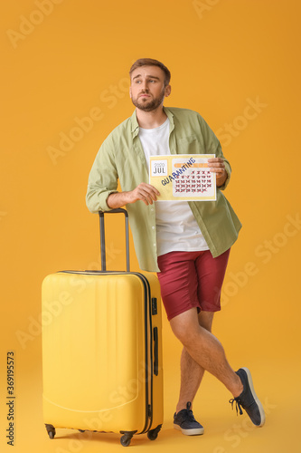 Sad man holding calendar wi...