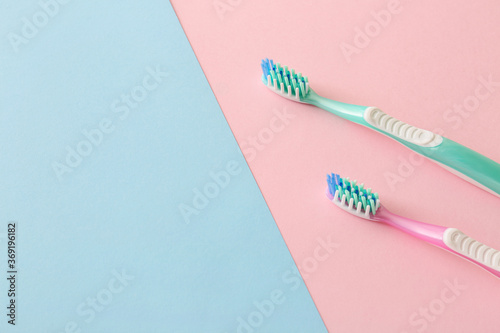 Tooth brushes on color background