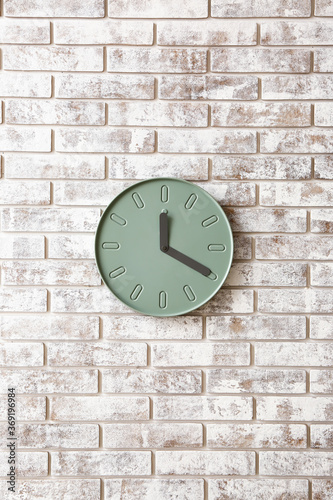 Simple clock on brick wall