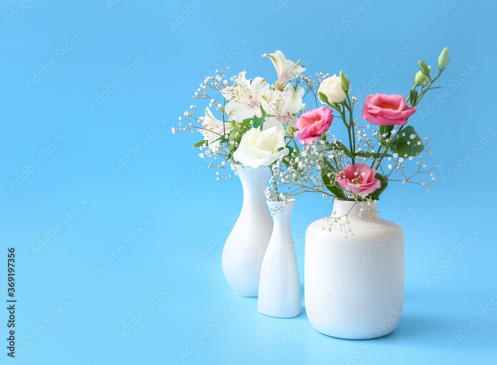 Beautiful vases with flowers on color background Beautiful vases with flowers on color background