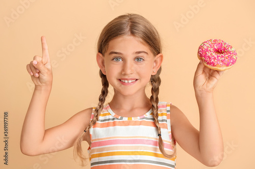 Funny little girl with donu...