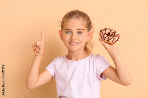 Funny little girl with donu...