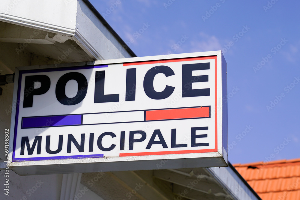 police municipale means in french Municipal police Station with flag and text sign