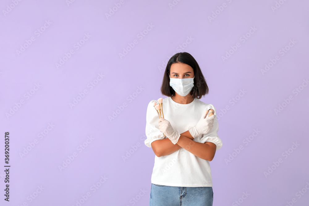 Female makeup artist wearing medical mask on color background. Coronavirus epidemic Female makeup artist wearing medical mask on color background. Coronavirus epidemic