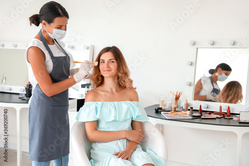 Female makeup artist workin...