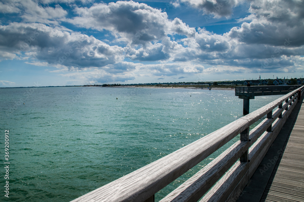 Wooden pier and sea scenery on a summer sunny day. Baltic Sea,  Heiligenhafen, Schleswig- Holstein, Germany