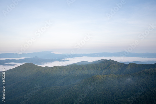beautiful view on top mountain and mist at morning light. soft focus. © suparat1983