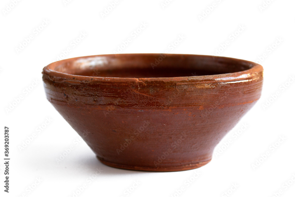 Old rough earthenware bowl close up isolated on white background Old rough earthenware bowl close up isolated on white background