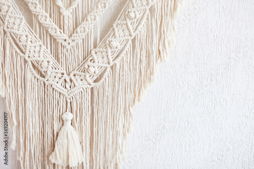 Close-up of hand made macrame texture pattern. ECO friendly modern knitting DIY natural decoration concept  in the interior. Flat lay. Handmade macrame 100% cotton. Female hobby. photo