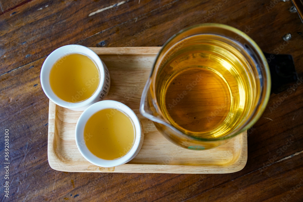simple still life with green tea, flat lay. Chinese tea in a transparent teapot and two traditional white Asian mugs. On a wooden table and a tray
simple still life with green tea, flat lay. Chinese tea in a transparent teapot and two traditional white Asian mugs. On a wooden table and a tray