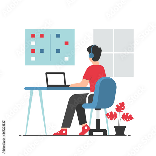 Office worker in casual clothes sitting at desk and working on laptop. Professional office worker at workplace