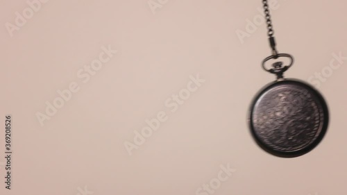 The hypnotist, the magic pendulum swings in the backlight in front of the camera.