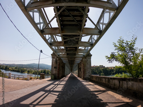 Fototapeta Naklejka Na Ścianę i Meble -  Valença Road-Railway Bridge, also known as Ponte de Valenca or Ponte Internacional de Tuy, is a road and rail bridge, crossing the Minho River on the border between Portugal and Spain.