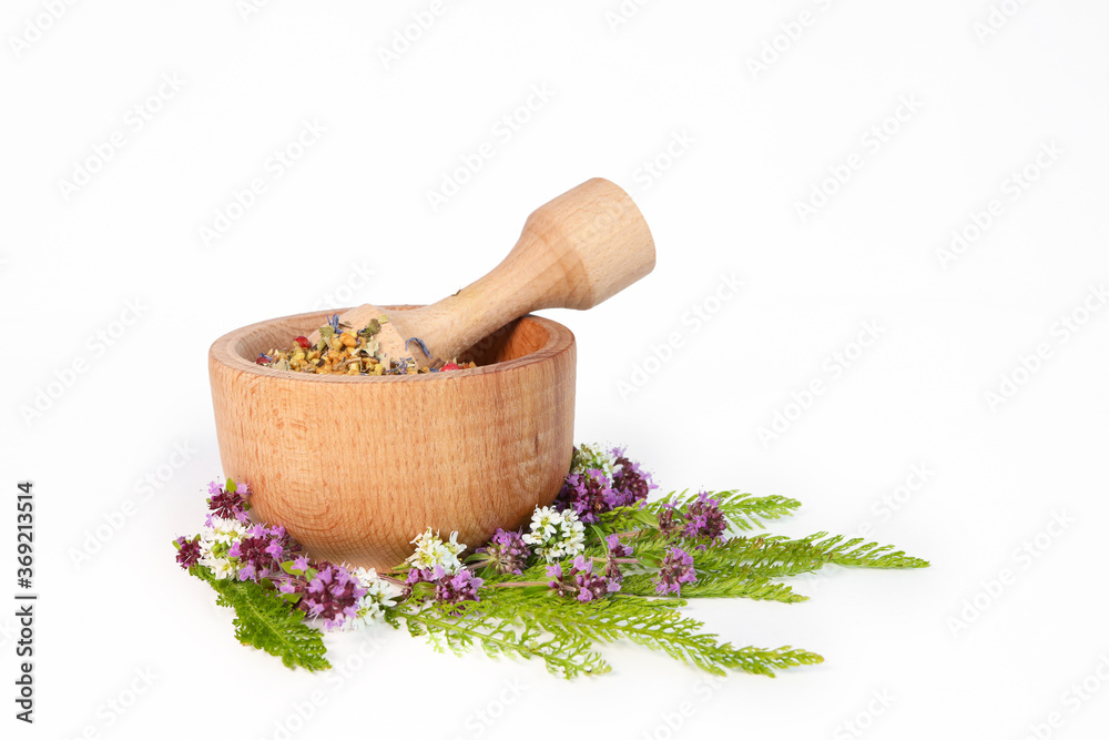 Herbs in porcelain mortar on white background. herbs in a mortar. flowers with thyme