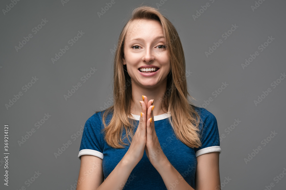Confused young blonde woman startled by offensive words, points at herself with forefinger, has questioning expression, wears blue t shirt. Human emotions, facial expression concept. Confused young blonde woman startled by offensive words, points at herself with forefinger, has questioning expression, wears blue t shirt. Human emotions, facial expression concept.