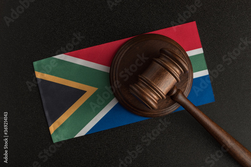 Judges hammer and flag of South Africa. Law of South Africa. Violation of rights