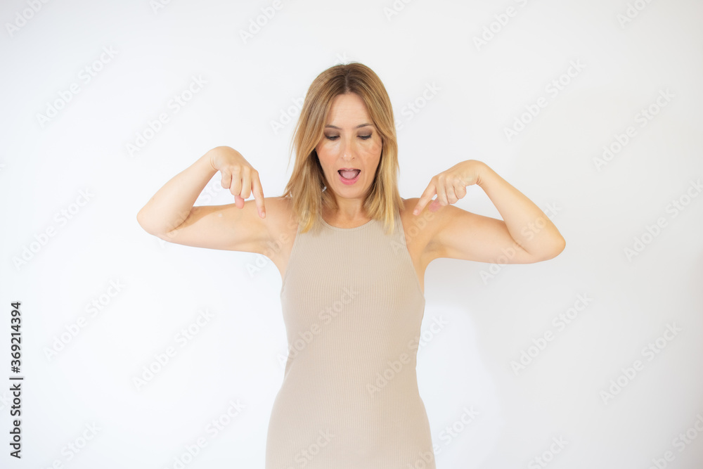 Beautiful blonde woman in beige dress gesturing Beautiful blonde woman in beige dress gesturing