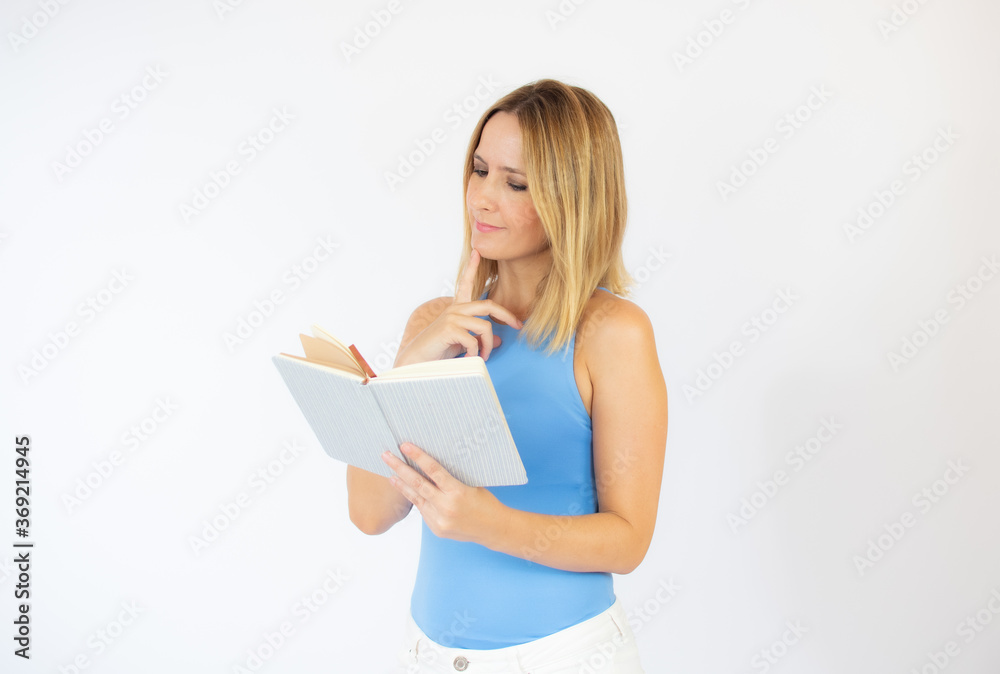 Beautiful woman in blue shirt reading a book Beautiful woman in blue shirt reading a book