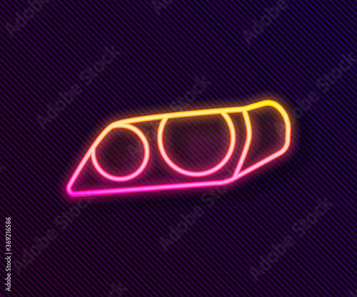 Glowing neon line Car headlight icon isolated on black background. Vector Illustration.