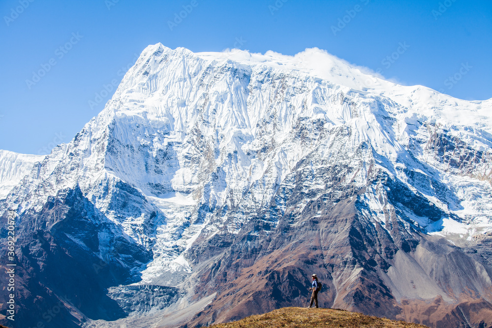 A middle aged woman trekking the Annapurna trek in the Himalayas, Nepal
