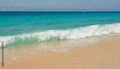 
blue sea, white wave and clean sand on the cleopatra beach in alanya
