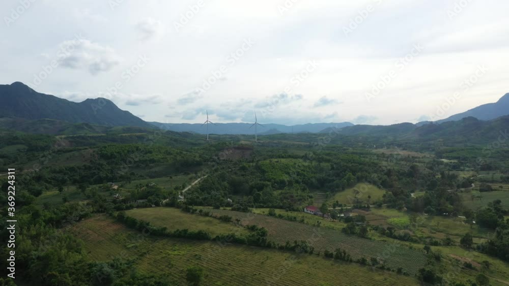 Aerial view of windmills farm for energy production on rice field, Huong Linh, Quang Tri, Vietnam. Wind power turbines generating clean renewable energy for sustainable development Aerial view of windmills farm for energy production on rice field, Huong Linh, Quang Tri, Vietnam. Wind power turbines generating clean renewable energy for sustainable development
