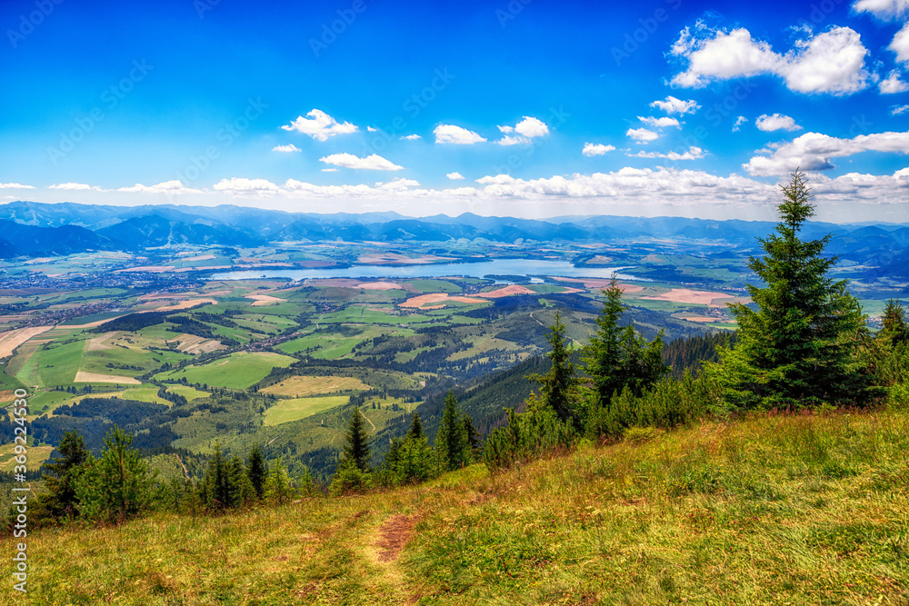 Obraz premium Landscape view on region Liptov and lake Liptovska Mara from hill Babky in Western Tatras