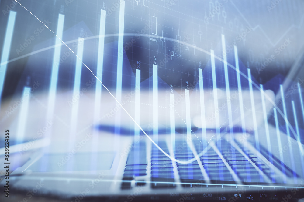 Forex market chart hologram and personal computer background. Multi exposure. Concept of investment. Forex market chart hologram and personal computer background. Multi exposure. Concept of investment.