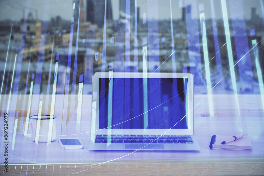 Financial graph colorful drawing and table with computer on background. Double exposure. Concept of international markets. Financial graph colorful drawing and table with computer on background. Double exposure. Concept of international markets.